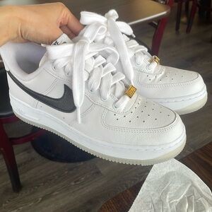Nike White and Black Sneakers with Gold Accents